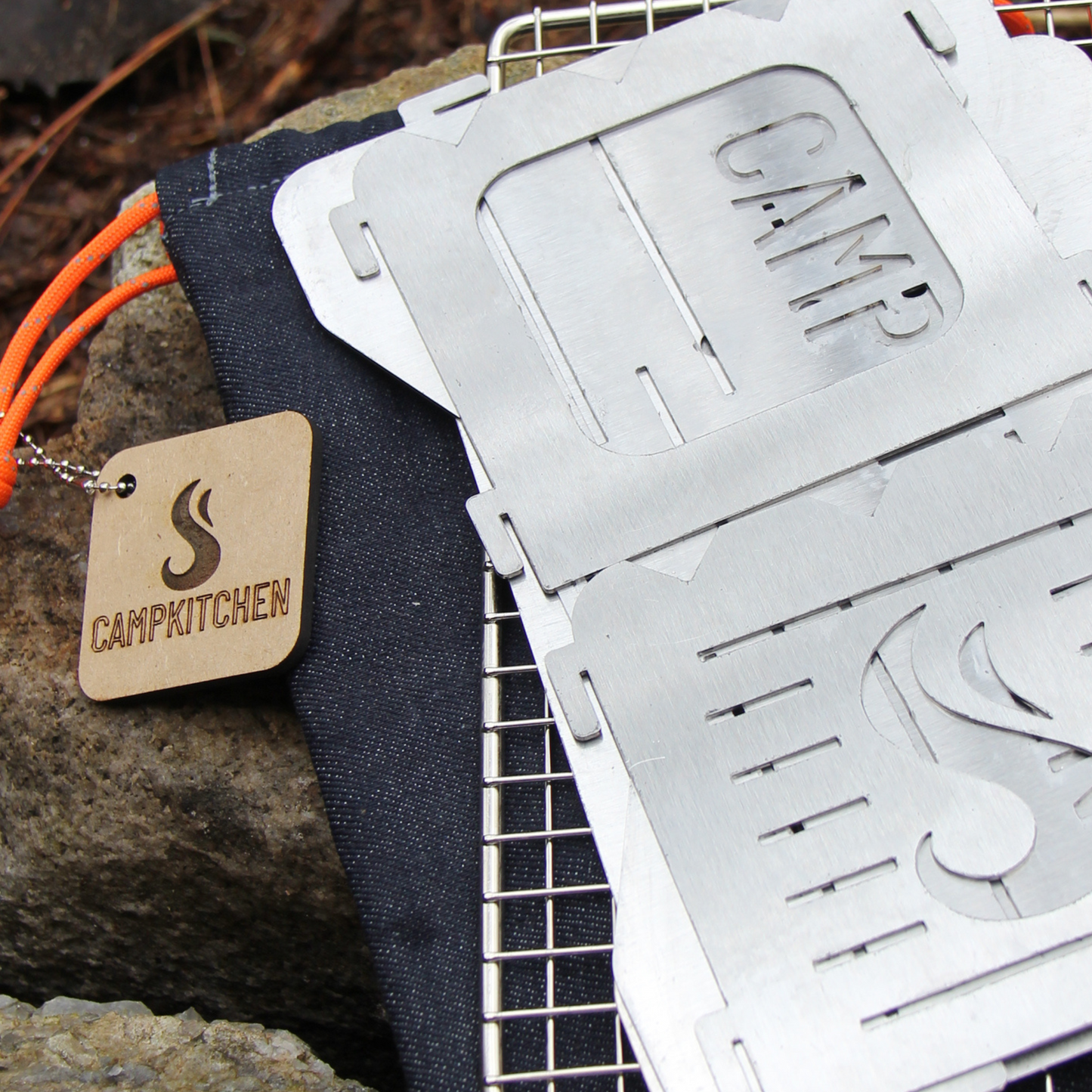 CAMPKITCHEN Twig Stove panels laid flat on top of the hand stitched denim bag.